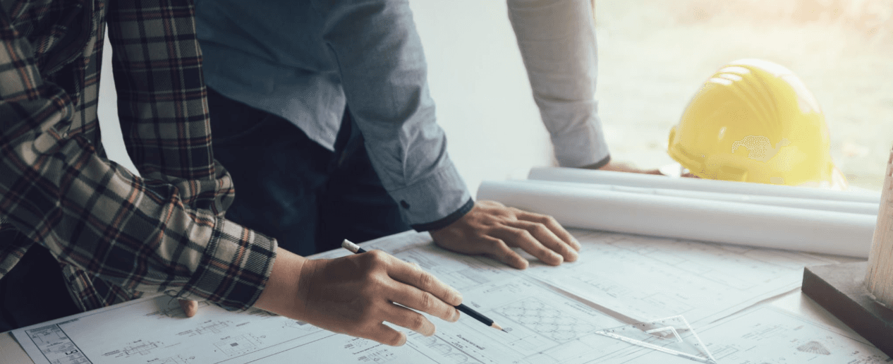 Team reviewing architectural blueprints and plans on site